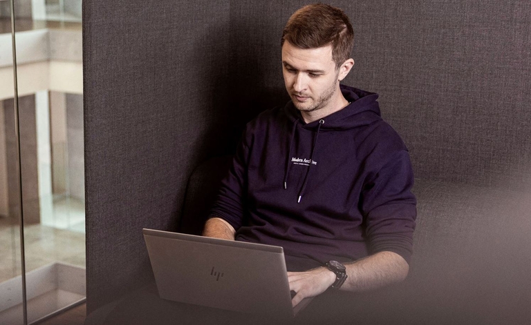 Carl Reid working on a laptop